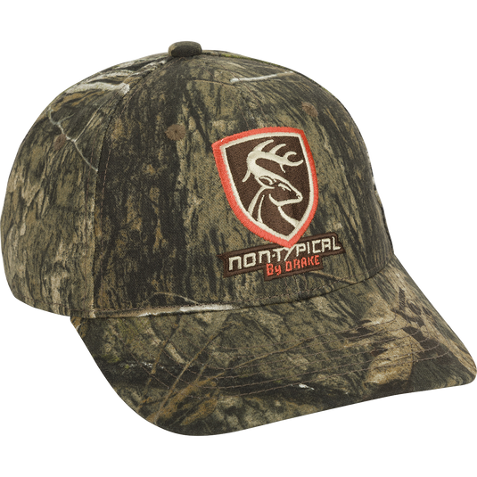 Non-Typical Logo Camo Cotton Cap with a deer logo patch, six-panel construction, and adjustable hook & loop closure, ideal for hunting. Made from 100% cotton.