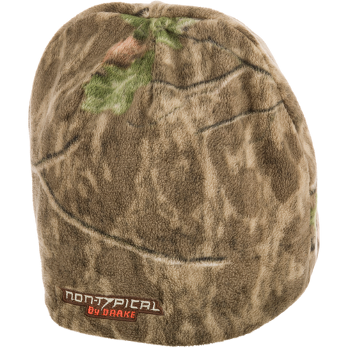 Non-Typical Camo Windproof Fleece Beanie with deep-cut design for ear coverage, featuring a camouflage pattern and a close-up of its label.