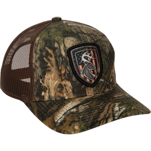 Americana Shield Patch Mesh-Back Cap with deer head and flag patch, breathable mesh back, lightly structured cotton twill front, and adjustable snap closure.