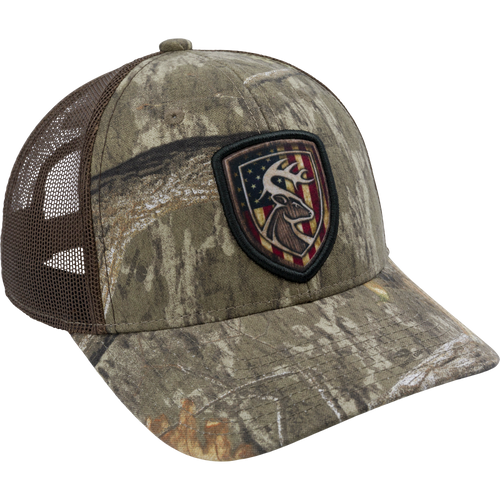 Americana Shield Patch Mesh-Back Cap with a deer head and stars and stripes patch, featuring a 100% cotton twill front and snap closure mesh back.