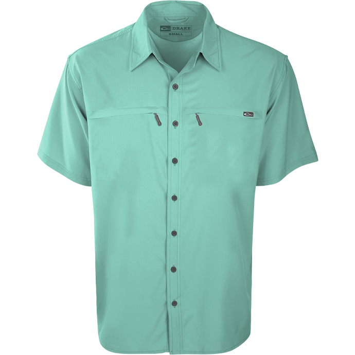 Close-up of the Drake Town Lake Short Sleeve Shirt, featuring a lightweight, breathable polyester fabric, button-up design, and two horizontal zipper pockets.