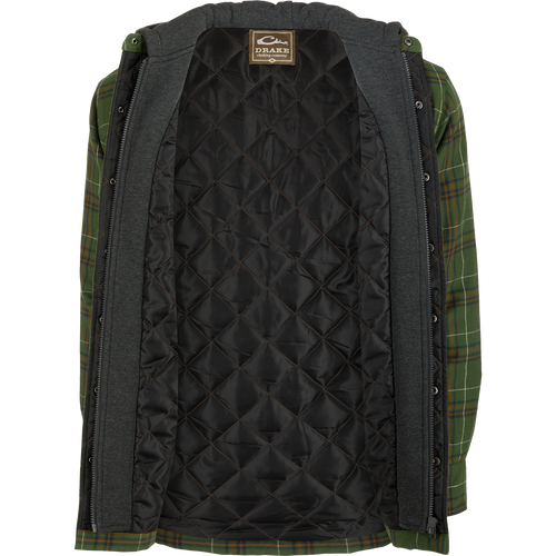 A person wearing the Drake Campfire Flannel Hoodie, a green and black plaid jacket with quilted insulation and an adjustable hood.