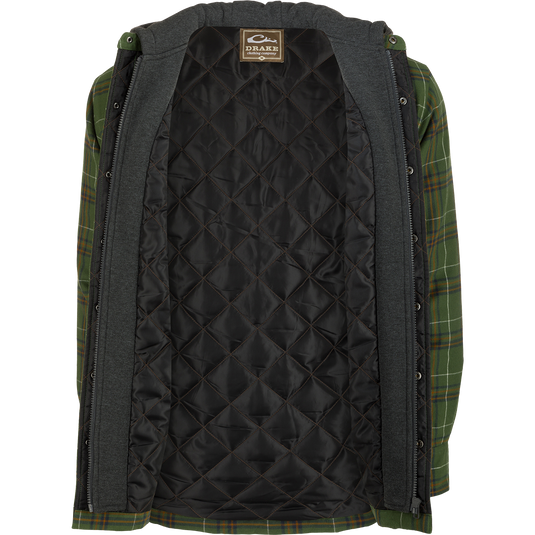 A person wearing the Drake Campfire Flannel Hoodie, a green and black plaid jacket with quilted insulation and an adjustable hood.