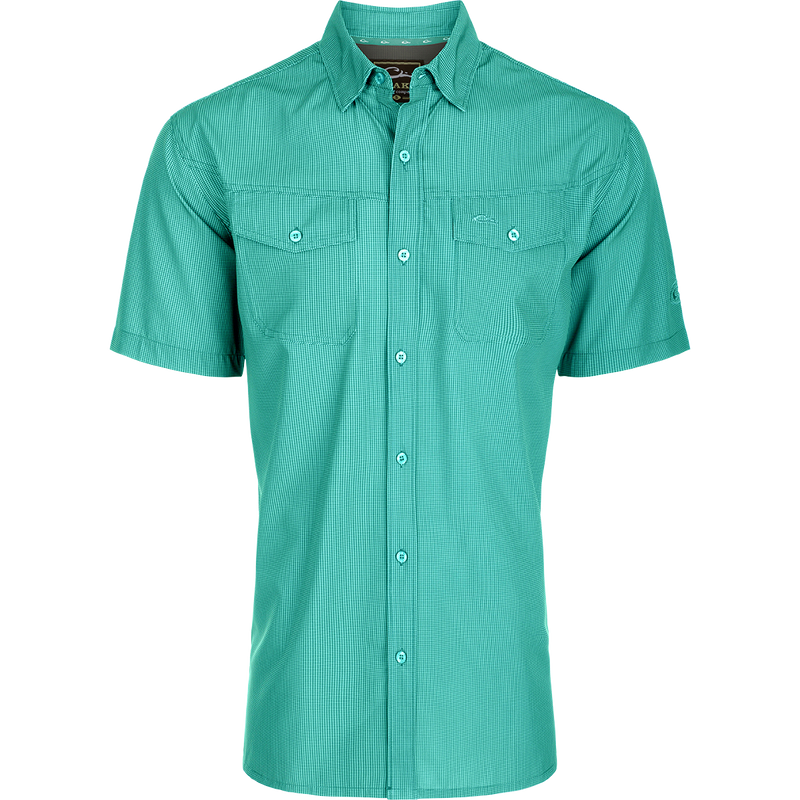 Traveler's Check Button-Down Short Sleeve Shirt with a checkered pattern, featuring two chest pockets with button flaps, designed for comfort and mobility.