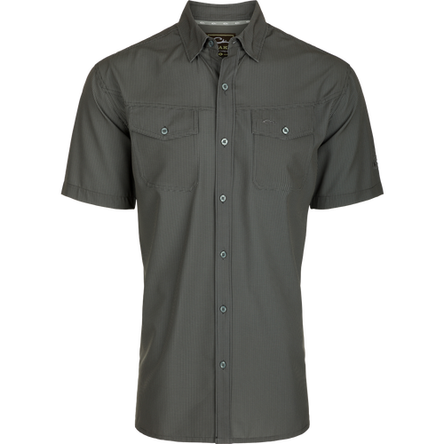 Alt text: Close-up of the Traveler's Check Button-Down Short Sleeve Shirt, featuring button flaps on chest pockets and lightweight, breathable poly/spandex fabric.