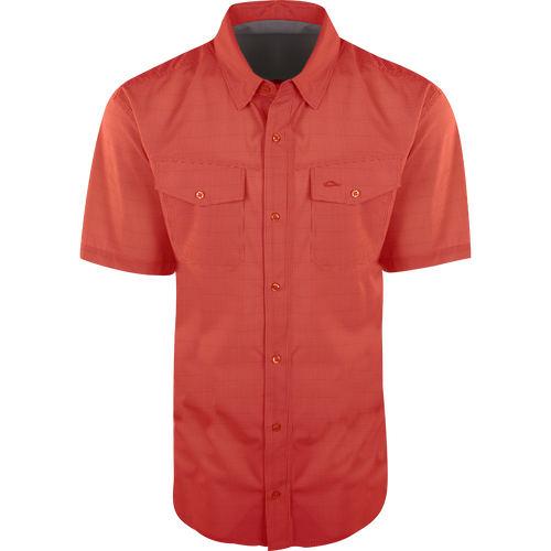 Traveler's Check Button-Down Short Sleeve Shirt with two chest pockets, button flaps, and a collar, designed for comfort and mobility with four-way stretch fabric.