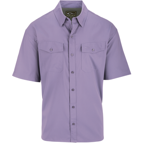 Traveler's Solid Dobby Button-Down Short Sleeve Shirt with hidden button-down collar, two chest pockets with flaps, and split tail hem. Made of lightweight, moisture-wicking polyester fabric.