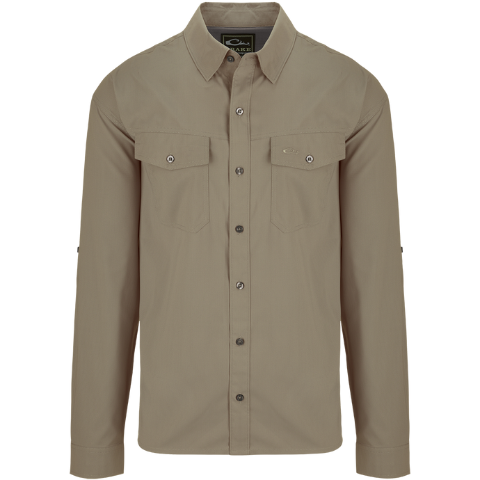 Traveler's Solid Dobby Shirt L/S: A classic fit, long-sleeved shirt with hidden button-down collar, chest pockets, and split tail hem. Made of featherweight, moisture-wicking fabric with UPF30 sun protection. Versatile for any occasion.