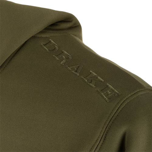 Alt text: Close-up of Drake Back Eddy Embossed Logo Hoodie, showcasing raised logo on polyester fabric. Features DWR coating, kangaroo pocket, and adjustable hood drawstrings. Ideal for outdoor activities.