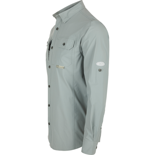 Wingshooter Trey Shirt L/S: Long-sleeved, performance fabric with hidden button-down collar, two chest pockets, vented cape back, adjustable sleeves, and sunglass wipe.