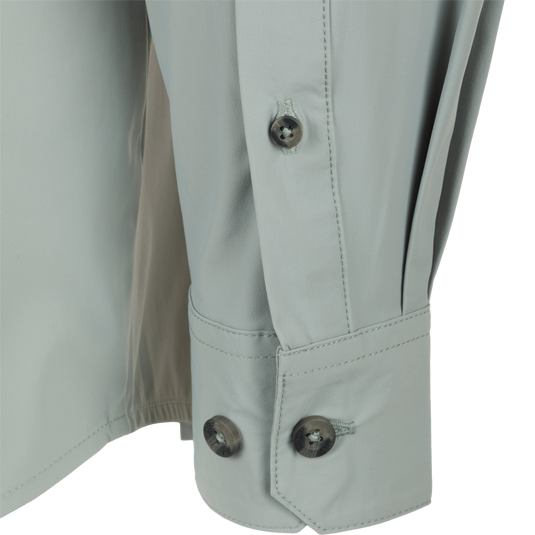 Close-up of a button on the Drake Wingshooter Trey Shirt L/S, showcasing its detailed craftsmanship and performance fabric.