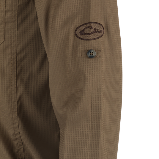 Close-up of Wingshooter's Trey Dobby Button-Down Long Sleeve Shirt, highlighting button detail and textured fabric, showcasing technical features like moisture-wicking and sun protection.