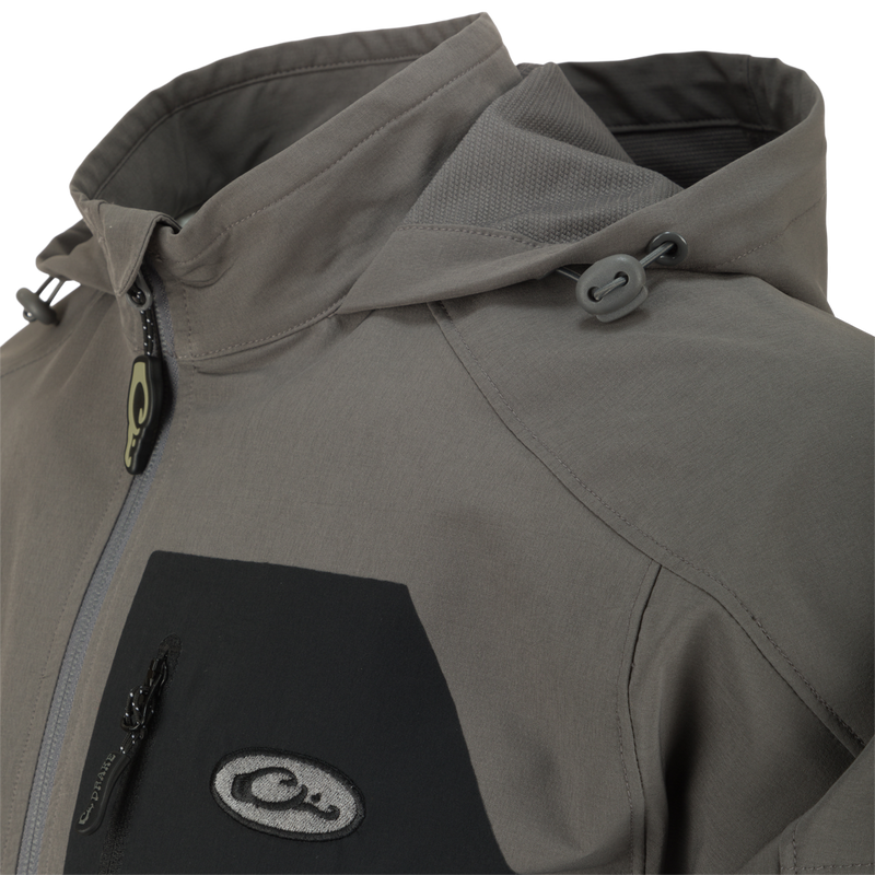 Close-up of the Rain Brake Lightweight Softshell Jacket featuring adjustable hood, YKK zippers, and water-resistant fabric, highlighting its functional design for outdoor activities.