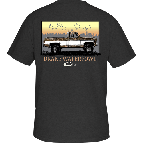 Back of the Old School Truck T-Shirt featuring a truck driven by a dog and birds flying above, with a front chest pocket displaying the Drake Logo.