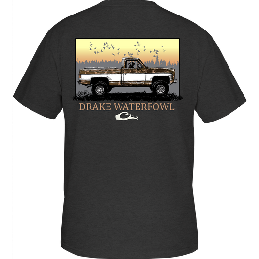 Back of the Old School Truck T-Shirt featuring a truck driven by a dog and birds flying above, with a front chest pocket displaying the Drake Logo.