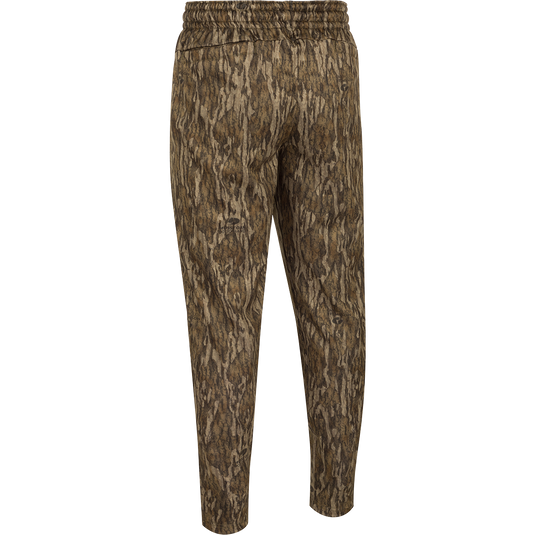 MST Waterfowl Under-Wader Jogger, featuring a camouflage pattern, tapered legs, front slash pockets, and Magnattach™ closure rear pockets, ideal for wearing under waders or lounging.