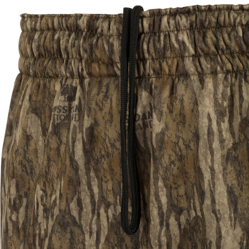 Close-up of the MST Waterfowl Under-Wader Jogger, showcasing camouflage pattern, tapered legs, front slash pockets, and Magnattach™ closure back pockets.