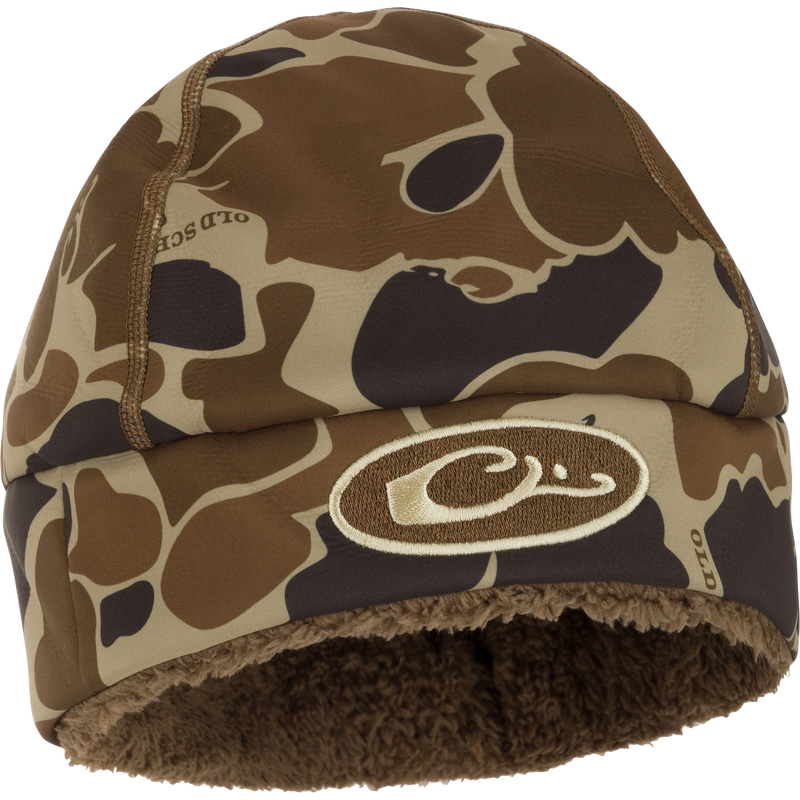 LST Windstopper Beanie: A camouflage hat with a logo, perfect for hunting and outdoor activities.