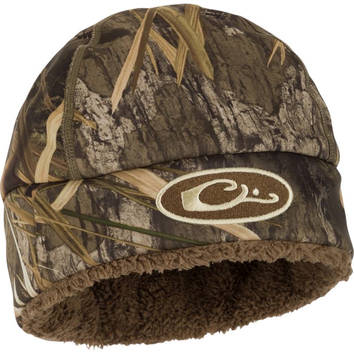 A close-up of the LST Windstopper Beanie, featuring a camouflage hat with a logo and fur lining.