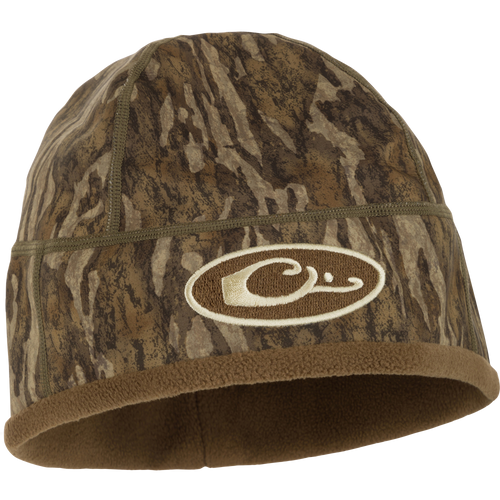 MST Windstopper Beanie featuring camouflage design and logo, crafted for warmth and wind resistance, fitting over ears for added protection.