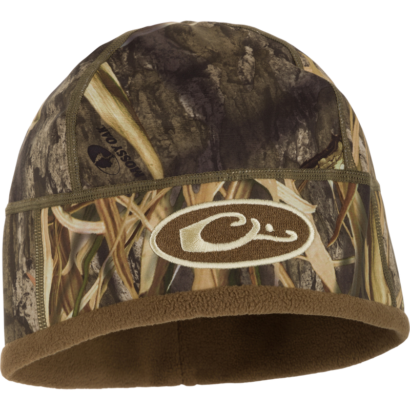 MST Windstopper Beanie with logo, featuring a camouflage design. Windproof and breathable, it covers ears for warmth, ideal for colder hunting days.