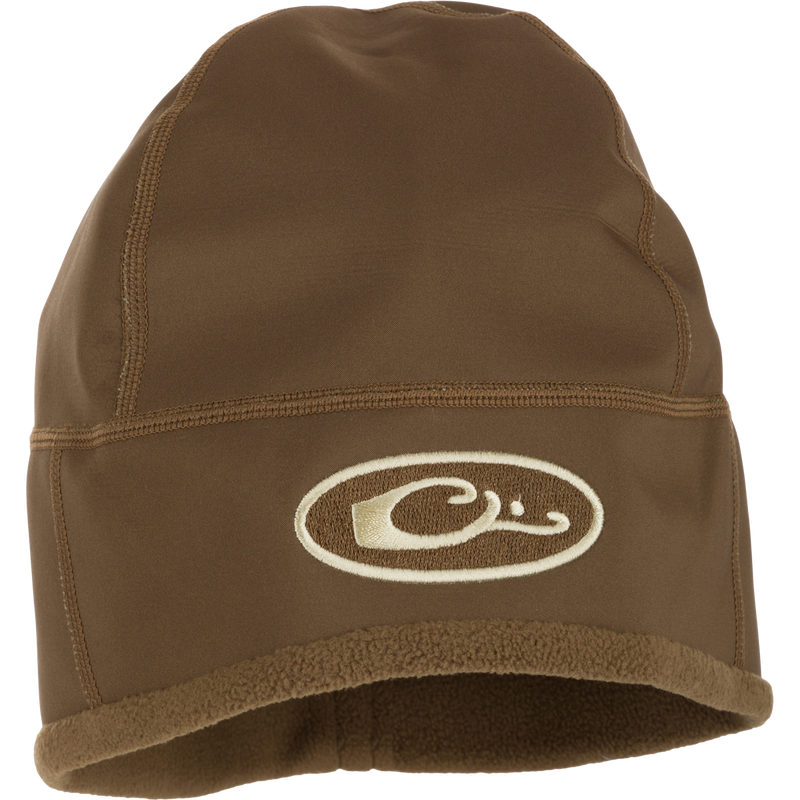 MST Windstopper Beanie, a brown hat with a logo, featuring a windproof breathable membrane and soft grid-fleece lining for ear coverage.