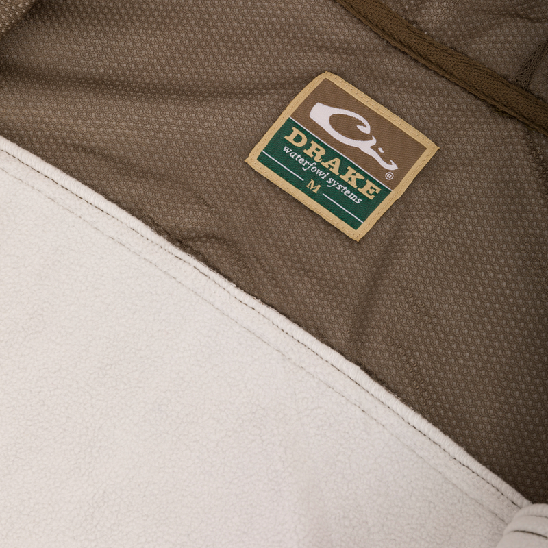 Technical Performance Fleece Full Zip Jacket label close-up, showcasing fabric and stitching details, emphasizing lightweight, breathable design ideal for hunting and outdoor activities.