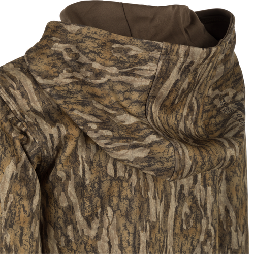 Close-up of the Youth MST Performance Hoodie - Realtree, highlighting its double-lined hood, kangaroo pouch, and soft, combed fleece interior for comfort and warmth.