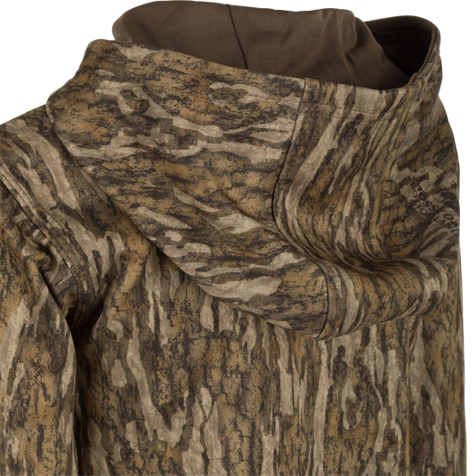 Close-up of the Youth MST Performance Hoodie - Realtree, highlighting its double-lined hood, kangaroo pouch, and soft, combed fleece interior for comfort and warmth.