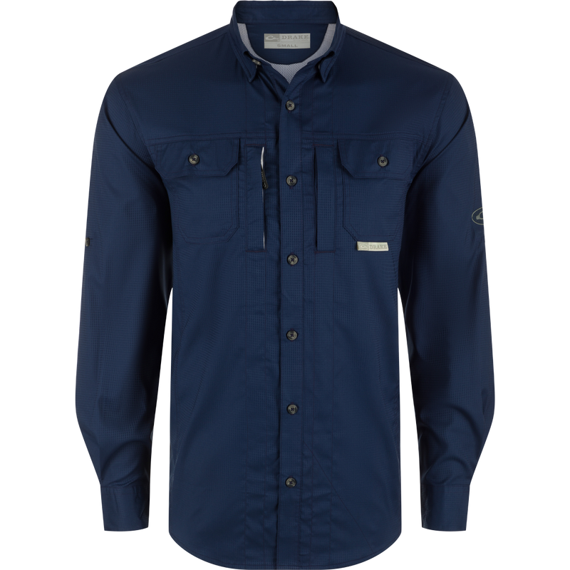 A performance-driven Wingshooters Trey Dobby Button-Down Shirt by Drake Waterfowl. Features include UPF30, moisture-wicking fabric, hidden collar, vented back, chest pockets, sunglass wipe, and adjustable cuffs.