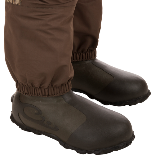 Women’s Insulated Guardian Elite Vanguard Breathable Waders featuring durable brown boots, reinforced seams, and multiple pockets for hunting in cold, wet conditions.