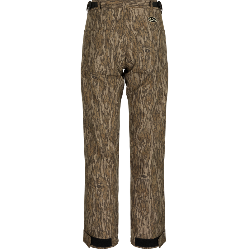 Alt text: MST Women’s Refuge Bonded Fleece Pants, camo pattern, waterproof/windproof/breathable, fleece lining, adjustable waist, ankle cuffs, stirrups, front and rear pockets.