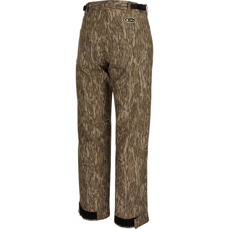 MST Women’s Refuge Bonded Fleece Pants: Waterproof camo trousers for duck hunting. Features fleece lining, ankle garters, and stirrups. Ideal for outdoor comfort.