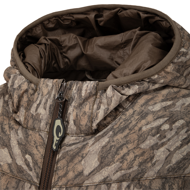 Close-up of MST Synthetic Down Hooded Jacket, highlighting the horizontal baffle design, insulated hood, and a zipper with Magnattach™ left chest pocket for hunting essentials.