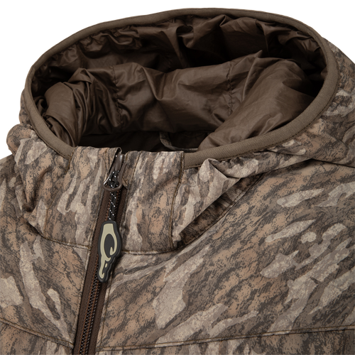 Close-up of MST Synthetic Down Hooded Jacket, highlighting the horizontal baffle design, insulated hood, and a zipper with Magnattach™ left chest pocket for hunting essentials.