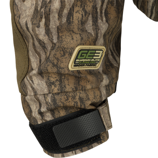 Close-up of the Guardian Elite™ LST Insulated Timber Jacket, highlighting camouflage knee pad, black strap, and durable fabric. Designed for hunters with practical features.