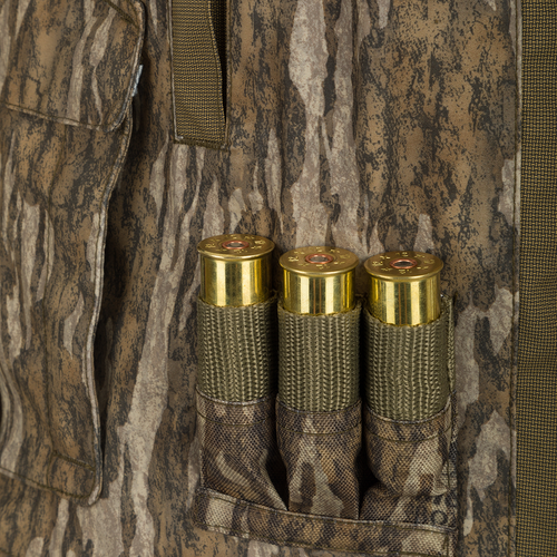 Close-up of the Guardian Elite™ LST Insulated Timber Jacket with camouflage fabric and reinforced material, featuring pockets and shell loops designed for hunting.