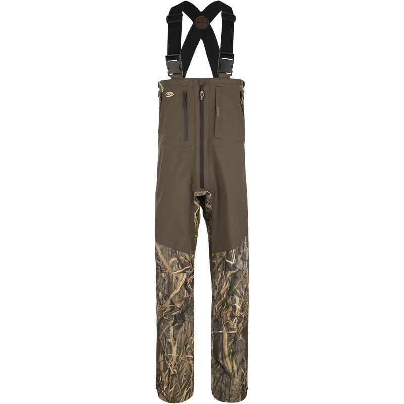 Guardian Elite Pro Ultralight 3-Layer Bibs, featuring waterproof fabric and multiple zippered pockets for storage, designed for ultimate protection and comfort in waterfowl hunting.