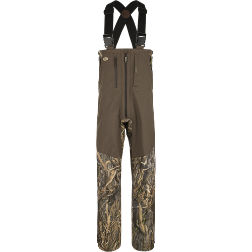 Guardian Elite Pro Ultralight 3-Layer Bibs, featuring waterproof fabric and multiple zippered pockets for storage, designed for ultimate protection and comfort in waterfowl hunting.