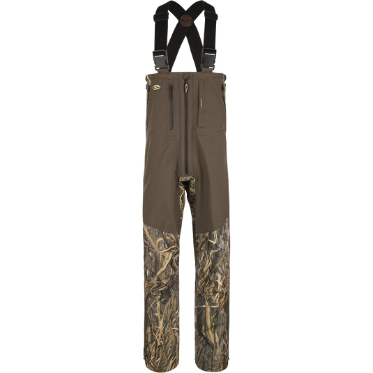 Guardian Elite Pro Ultralight 3-Layer Bibs, featuring waterproof fabric and multiple zippered pockets for storage, designed for ultimate protection and comfort in waterfowl hunting.