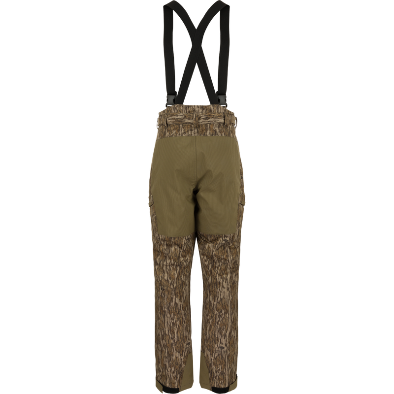 MST Waist-High Insulated Bibs with suspenders, featuring water-resistant zippers, cargo pockets, and reinforced knees, designed for optimal warmth and mobility in hunting conditions.