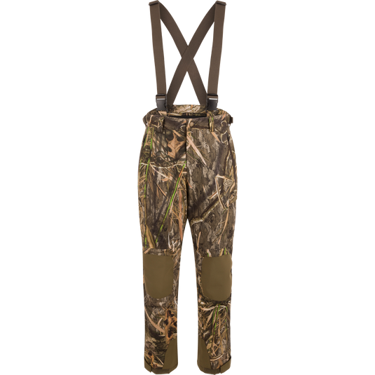MST Waist-High Insulated Bibs with camouflage pattern, suspenders, and multiple zippered pockets for secure storage; designed for hunting with waterproof, insulated material.