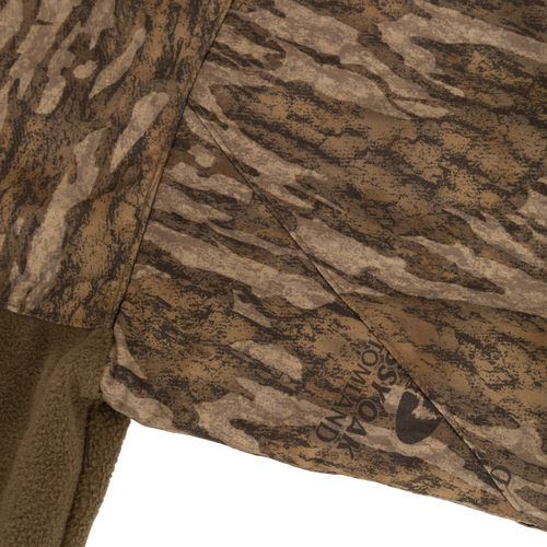 MST Quarter Zip Refuge Eqwader Jacket featuring camouflage fabric, highlighting waterproof and breathable materials with advanced features for waterfowl hunting comfort and performance.