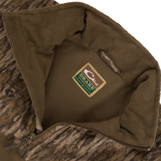 MST Quarter Zip Refuge Eqwader Jacket featuring patented waterproof and breathable fabric, close-up of zipper and label, designed for optimal waterfowl hunting performance.