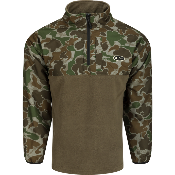 A camouflage MST 1/4 Zip Refuge Eqwader Pullover by Drake Waterfowl, featuring waterproof Refuge HS™ fabric with HyperShield™ 2.0 tech for comfort and performance in waterfowl hunting.