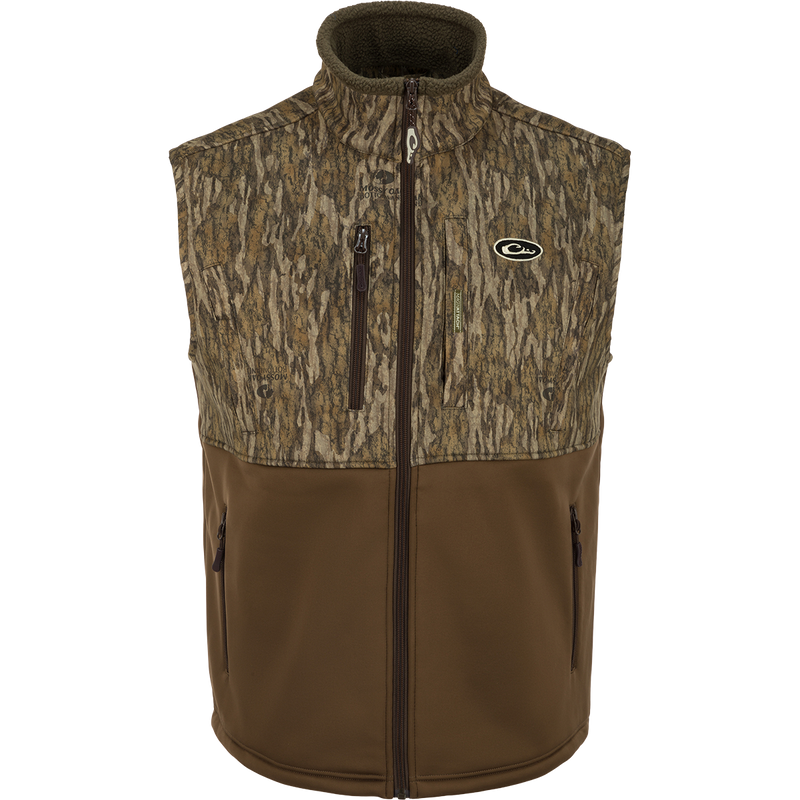 Hole Shot Windproof Eqwader Vest with camouflage pattern, featuring a 3-layer windproof upper, sherpa-lined lower, handwarmer pockets, zippered slash pockets, and adjustable waist.