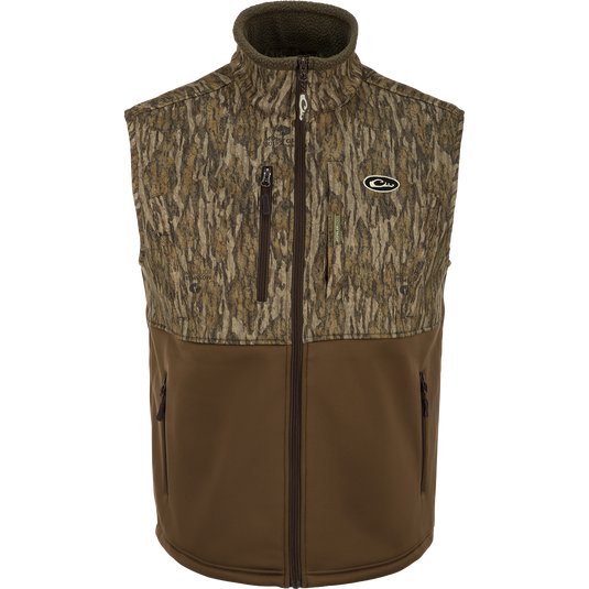 Hole Shot Windproof Eqwader Vest with camouflage pattern, featuring a 3-layer windproof upper, sherpa-lined lower, handwarmer pockets, zippered slash pockets, and adjustable waist.