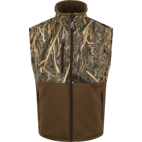 Hole Shot Windproof Eqwader Vest with camouflage pattern, featuring zippered pockets, adjustable waist, and sherpa-lined upper body for wind protection and warmth.