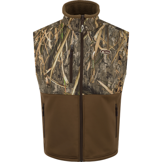 Hole Shot Windproof Eqwader Vest with camouflage pattern, featuring zippered pockets, adjustable waist, and sherpa-lined upper body for wind protection and warmth.