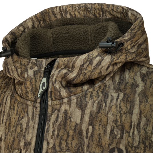 Close-up of the Ultimate Wader Quarter Zip Hoodie showcasing zipper, Sherpa-lined fabric, and Magnattach™ chest pocket, designed for warmth and functionality in mid-season hunting.